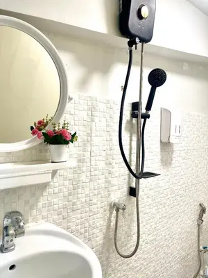 a shower in a bathroom with a mirror and a sink at Rhythm of life guesthouse 56 in Bangkok