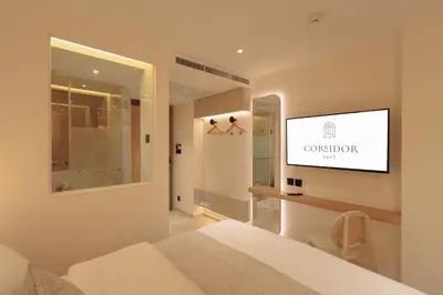 a bedroom with a flat screen tv on a wall at CORRIDOR 2407 in Bangkok