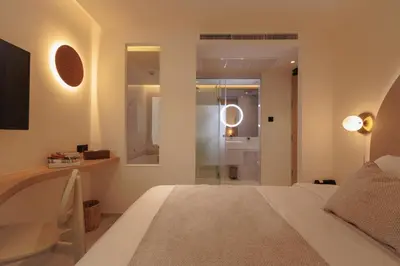 a bedroom with a bed and a walk in shower at CORRIDOR 2407 in Bangkok