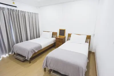 a bedroom with two beds and a window at Nitichai Place, Private Sukhumvit Townhome 8PAX in Bangkok