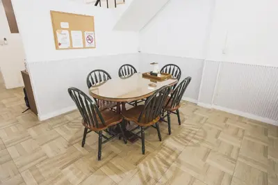 a dining room with a wooden table and chairs at Nitichai Place, Private Sukhumvit Townhome 8PAX in Bangkok