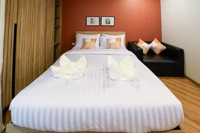 a large white bed with white flowers on it at You Hotel in Ban Zong Katiam