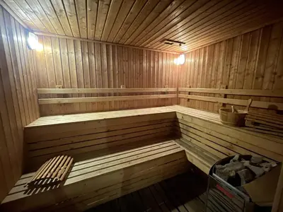 a wooden sauna with a bench in it at Luxurious Downtown condo w/train access in Bangkok