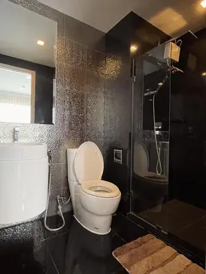 a bathroom with a toilet and a shower at Luxurious Downtown condo w/train access in Bangkok