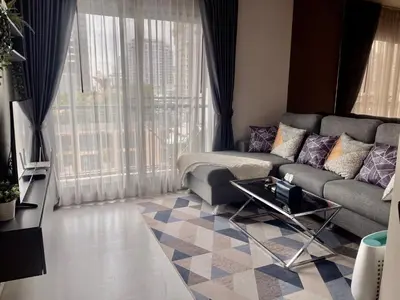 a living room with a couch and a table at Luxurious Downtown condo w/train access in Bangkok