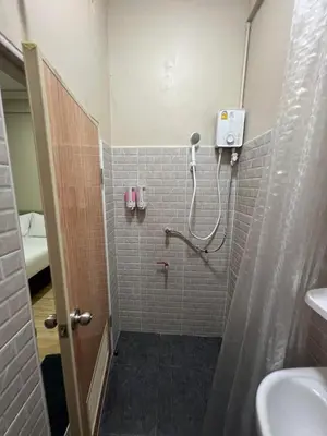 a bathroom with a shower and a sink at Bangwa House - MRT Bangwa Station in Bangkok