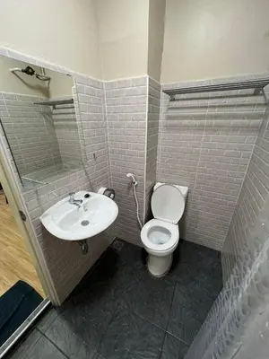 a bathroom with a toilet and a sink at Bangwa House - MRT Bangwa Station in Bangkok