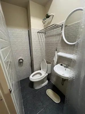 a bathroom with a toilet and a sink at Bangwa House - MRT Bangwa Station in Bangkok