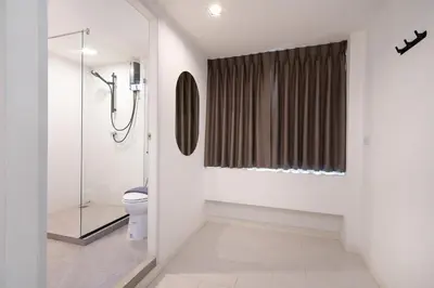 a bathroom with a shower and a toilet at The Urban Oasis in Bangkok