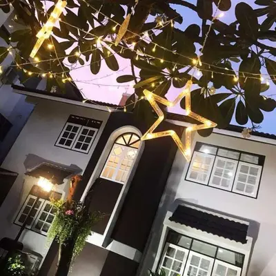 a house with christmas lights in front of it at Suttisan \u5730\u94c1\u53e3\u4e8c\u5c42\u72ec\u680b\u82b1\u56ed\u522b\u5885 \u4e94\u5367\u5ba4\u4e09\u536b in Bangkok