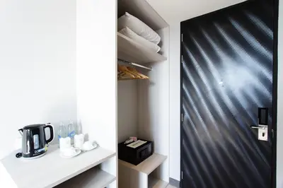 a black door in a room with a coffee maker at Jazzotel Bangkok in Bangkok