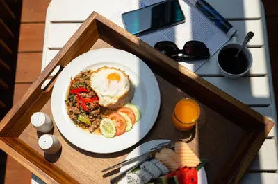 a plate of food with an egg on a table at Jazzotel Bangkok in Bangkok