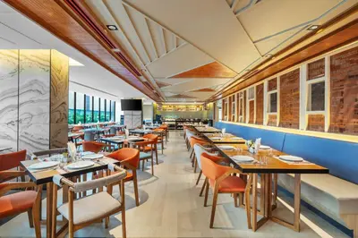a restaurant with tables and chairs in a room at Best Western Click Sathorn 11 Bangkok in Bangkok