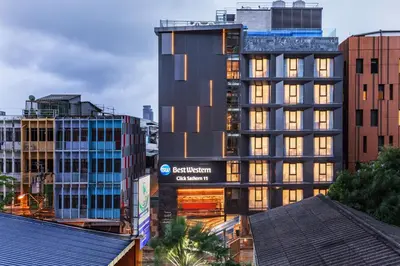 a tall building in a city with buildings at Best Western Click Sathorn 11 Bangkok in Bangkok