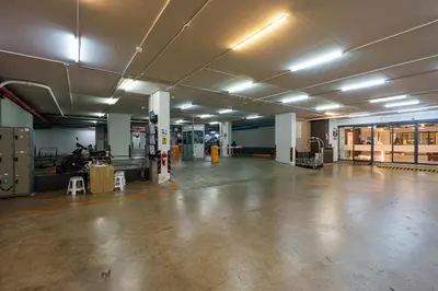 an empty garage with a large room with lights on the ceilings at Prom Hotel in Bangkok