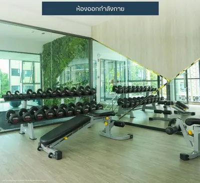 a gym with a row of treadmills and mirrors at Resort Style Room Suksawat 64 Bangkok ND in Ban Tha Hin
