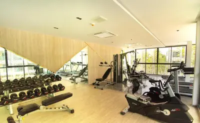 a gym with treadmills and exercise equipment in a room at Resort Style Room Suksawat 64 Bangkok ND in Ban Tha Hin