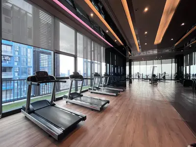 a gym with several treadmills and large windows at Thanon Phaya in Bangkok