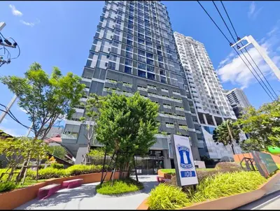 a tall building with a sign in front of it at Thanon Phaya in Bangkok