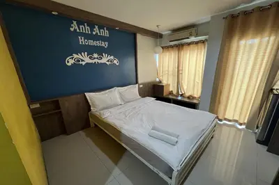 a small bed in a room with a blue wall at Anh Anh Homestay in Bangkok