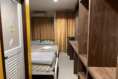a small room with two beds and a hallway at Anh Anh Homestay in Bangkok