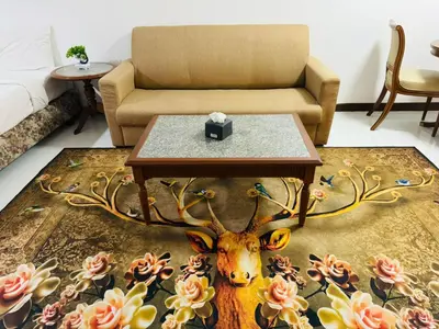 a living room with a table and a couch at Affordable Serviced Apartments in Nana Omni Tower - Prime Sukhumvit location in Bangkok