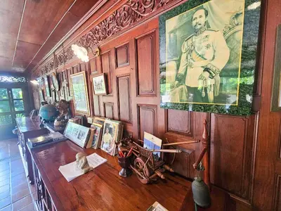 a room with a large picture of a man on the wall at The Thai House Homestay & Thai Cooking Experiences in Ban Bang Sano