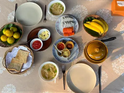 a table topped with plates and bowls of food at The Thai House Homestay & Thai Cooking Experiences in Ban Bang Sano