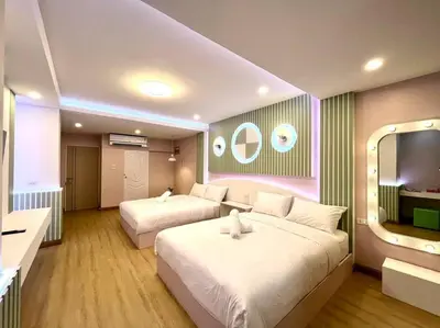 a hotel room with two beds and a television at DiscoveryHome4 at Pratunammarket in Bangkok