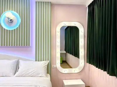 a bedroom with a white bed and a mirror at DiscoveryHome4 at Pratunammarket in Bangkok