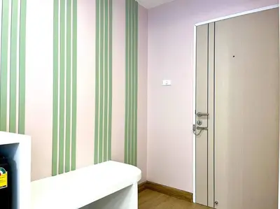 a bathroom with a mirror next to a door at DiscoveryHome4 at Pratunammarket in Bangkok