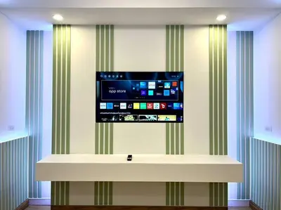 a flat screen tv on a wall in a room at DiscoveryHome4 at Pratunammarket in Bangkok