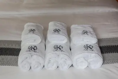 a group of white slippers on a bed at Chic loft in Bangkok