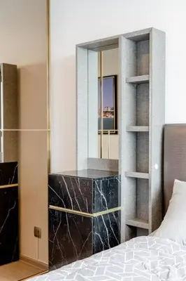 a bedroom with a large mirror and a bed at 1 BR plus@42th FL /2-3 min walk to BTS MRT Ladprao in Bangkok