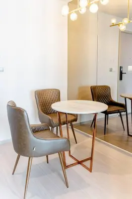 a table and chairs in a room with a table at 1 BR plus@42th FL /2-3 min walk to BTS MRT Ladprao in Bangkok