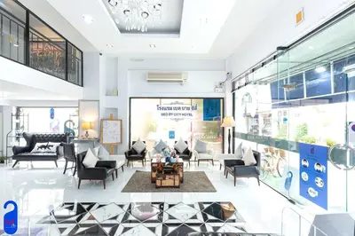 a lobby of a store with couches and chairs at Bed By City Hotel in Bangkok