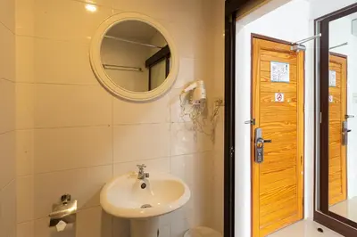 a bathroom with a sink and a mirror at Bed By City Hotel in Bangkok