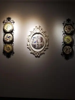 a wall with four clocks hanging on a wall at Bed By City Hotel in Bangkok