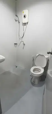 a white bathroom with a toilet and a sink at XX GO INN Khaosan Road Bangkok - โกอินน์ ถนนข้าวสาร กรุงเทพฯ in Bangkok