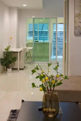 a vase sitting on a table in a living room at Entire 3BR Townhome in Sukhumvit, shared Pool, near BTS&MRT Asok in Bangkok