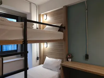 a bunk bed room with two bunk beds at N5 Ratchawong Hostel in Bangkok