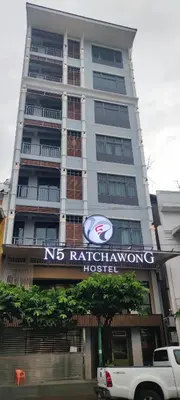 a tall building with a sign in front of it at N5 Ratchawong Hostel in Bangkok