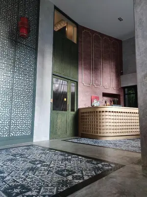 a kitchen with a green door and a counter at N5 Ratchawong Hostel in Bangkok