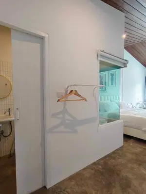 a white room with a bed and a glass door at Mr Black & Ms White -Self Check in accommodation in Pom Prap