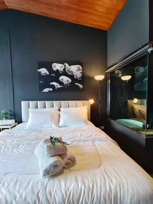 a bedroom with a large white bed with towels on it at Mr Black & Ms White -Self Check in accommodation in Pom Prap