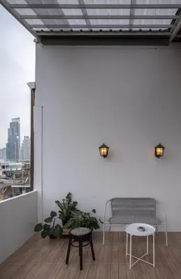 a white room with a bench and a table at Bedtime storeys near ICON SIAM in Bangkok