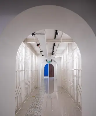 an empty hallway with white walls and an archway at Bedtime storeys near ICON SIAM in Bangkok
