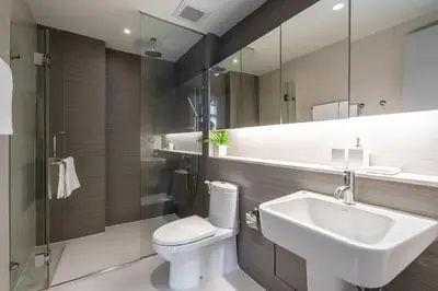 a bathroom with a sink and a toilet and a mirror at Destiny55 Thonglor Apartment in Bangkok