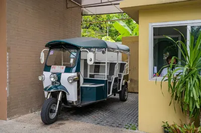 a small vehicle parked next to a building at Destiny55 Thonglor Apartment in Bangkok