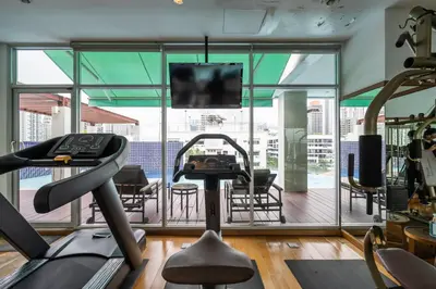 a gym with a view of a balcony at Destiny55 Thonglor Apartment in Bangkok